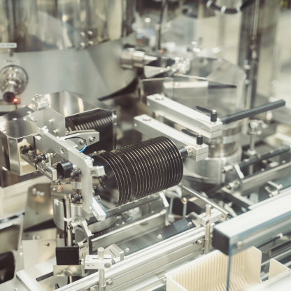 Stack of hard drive platters being processed inside automated manufacturing equipment