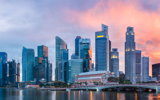 Singapore skyline at sunset over the water