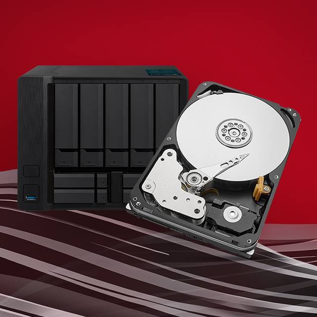 The inside components of a Seagate IronWolf NAS hard drive in the foreground with a multi-bay NAS system behind it