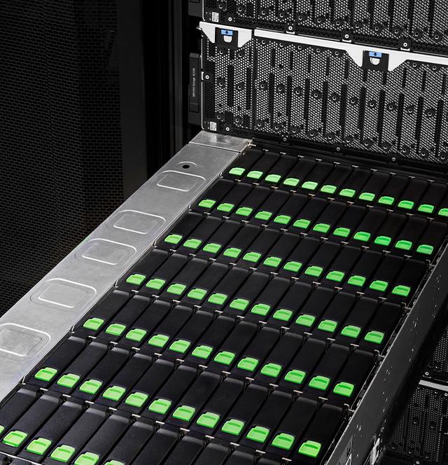 Close-up of a Seagate storage enclosure drawer packed with green-latched hard drives, illustrating maximum-density capacity