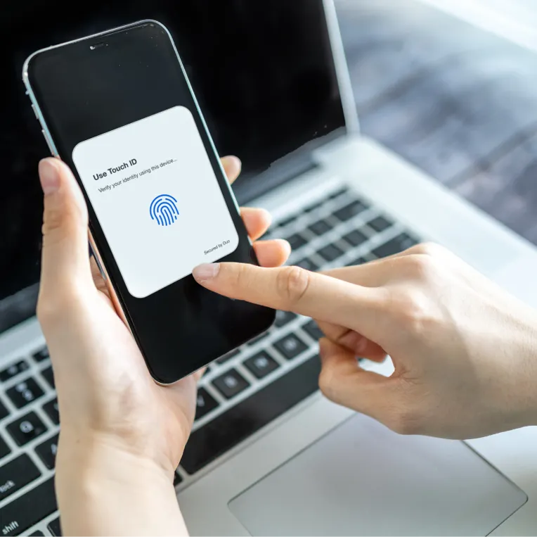 Closeup of person holding smartphone using Duo Touch ID