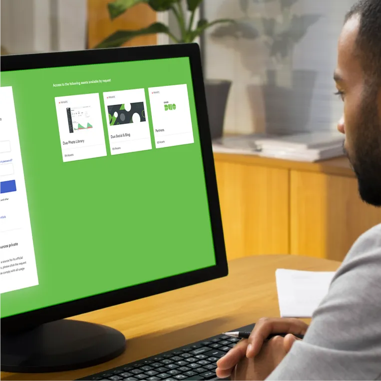 Person at desk viewing screen with Duo photo library sections