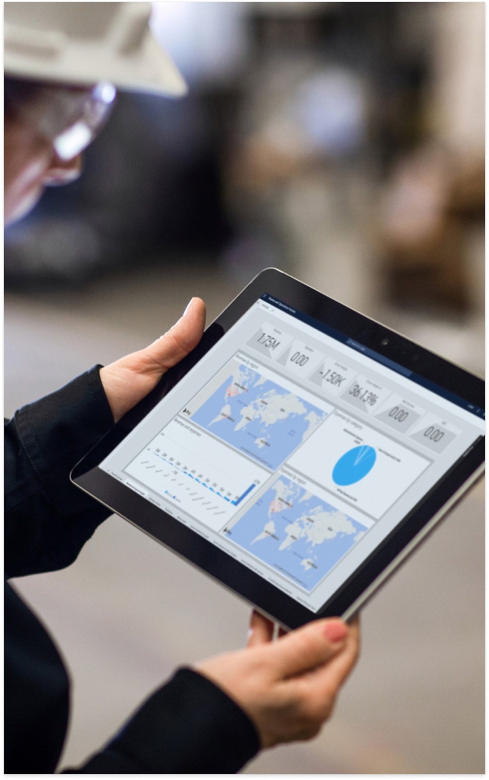 A person holding a tablet showing a document with charts and a map.