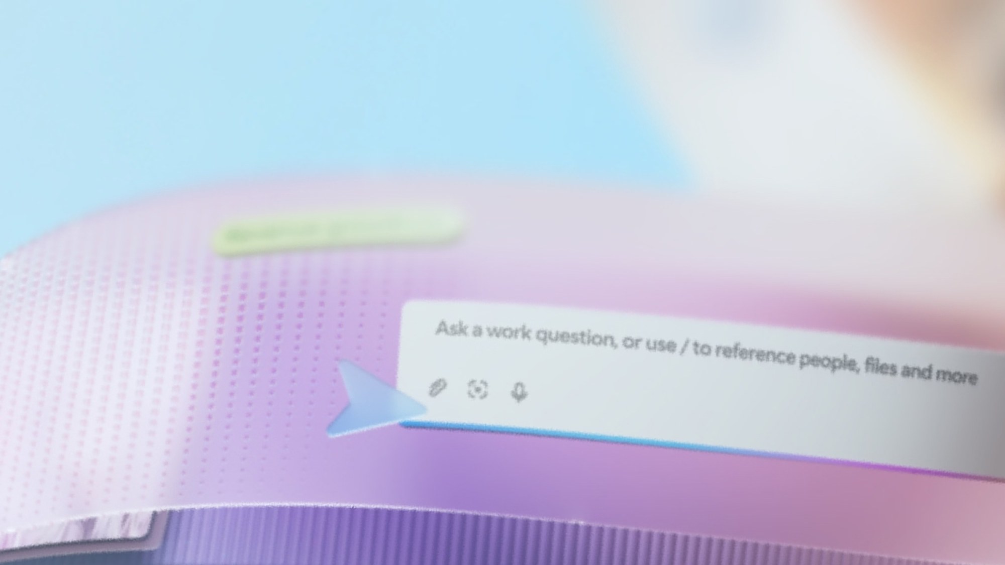 Close-up of a chat box reading &ldquo;Ask a work question, or use / to reference people, files and more&rdquo; with attach, capture and microphone icons below it, on a pink and purple gradient surface.