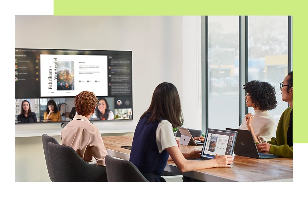 A group of people sitting in conference room and discussing by looking at screen