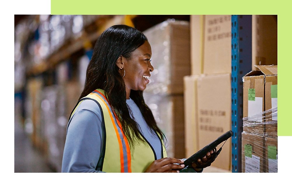 A lady is looking at parcel boxes and smiling