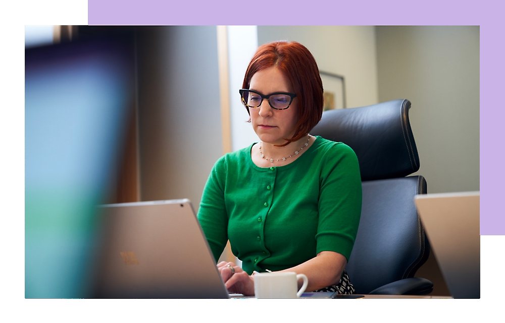 A woman is working on a laptop