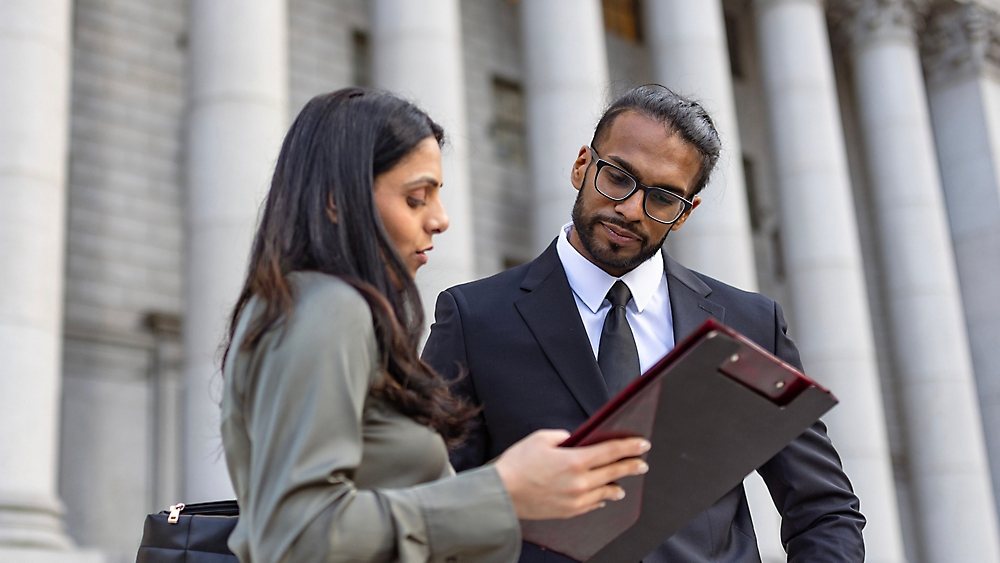 A Man and women looking at notepad and discussing